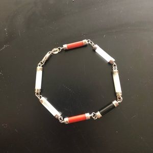 Red, black, and white bracelet